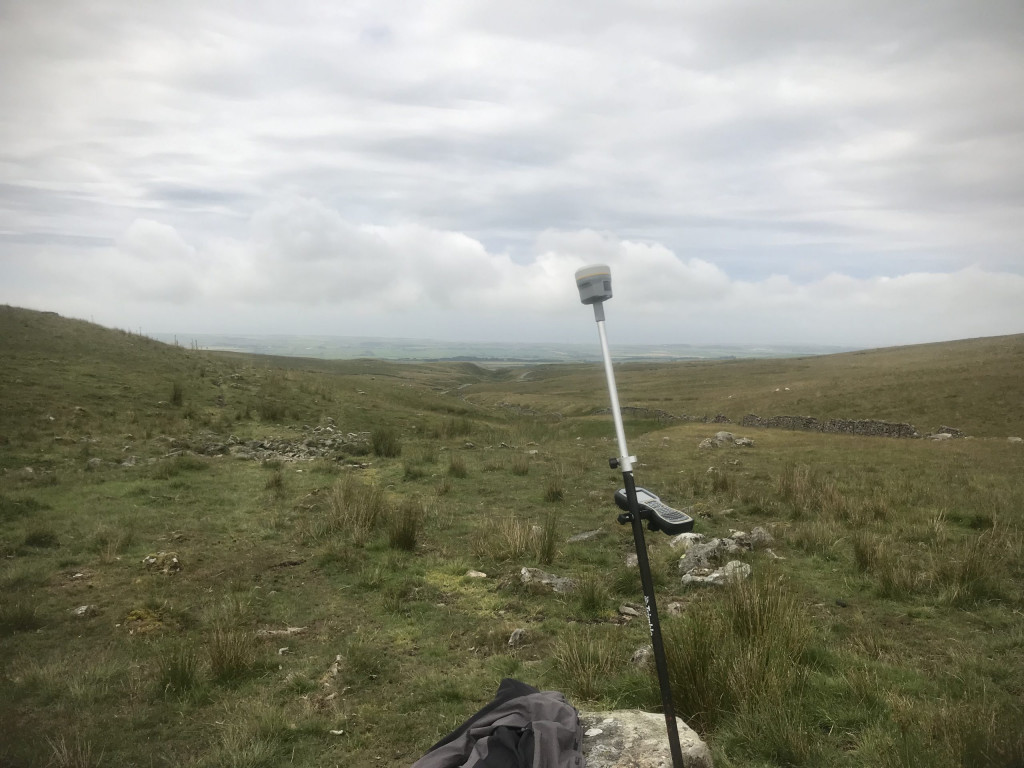 Trimble R10 leaning against rock in the wilderness