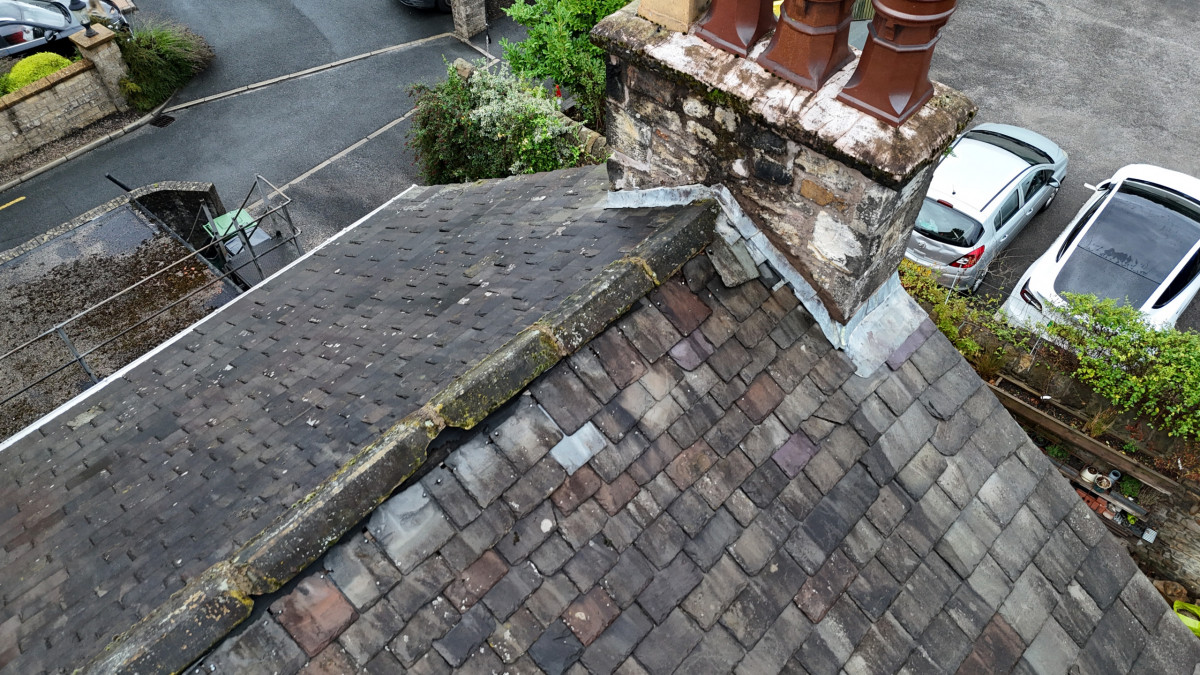 Drone roof inspection showing chimney, lead flashing and slate roof